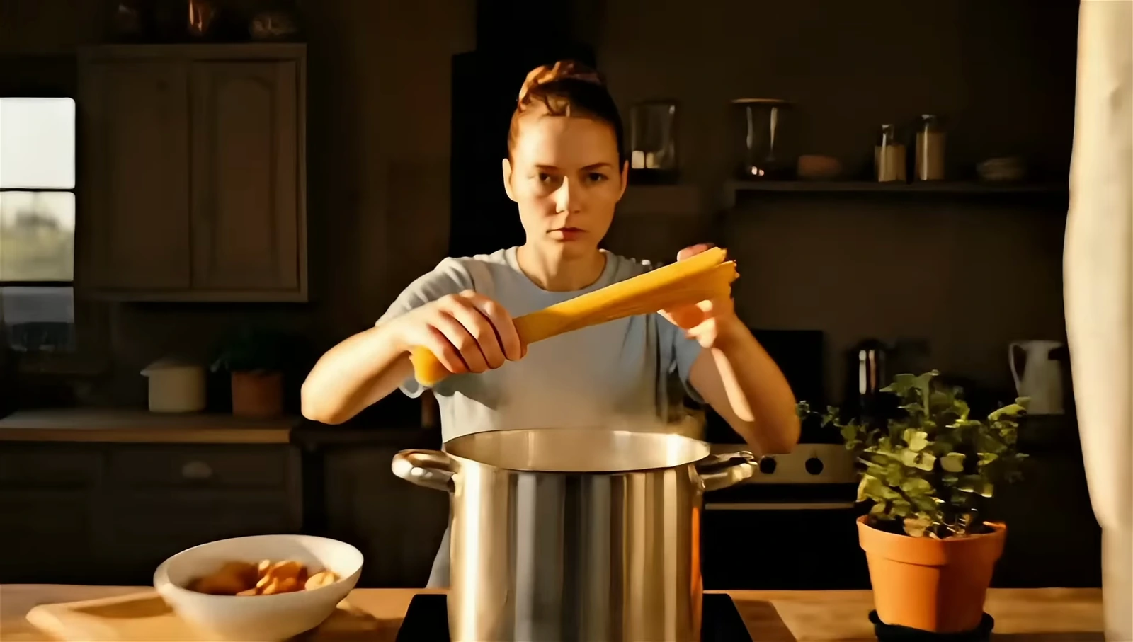 Spaghetti being prepared in a warm kitchen.
